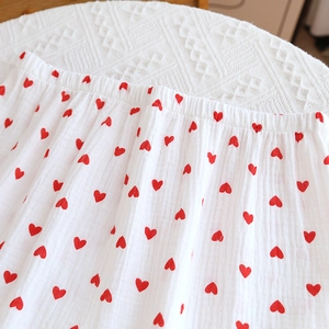 Close-up of soft double-layer cotton gauze pajamas with red heart prints and elastic waist