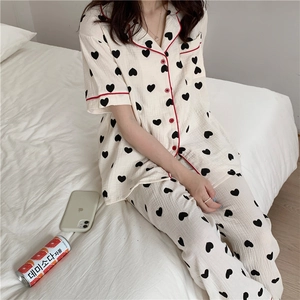Detail of soft cotton gauze pajamas featuring heart print and red contrast piping