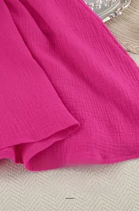 Detailed macro view of high quality rose pink crepe cotton fabric with soft pleated texture