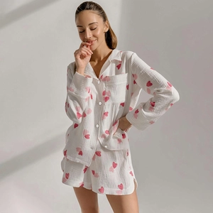 Detail of soft cotton heart print pajama set showing fabric texture and pink heart patterns