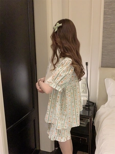 Detail of cute bear print pajamas set with green stripes and ruffled hem edges