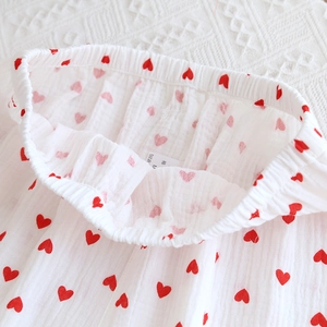 Close-up of cotton pajama waistband featuring red heart print and elastic band detail