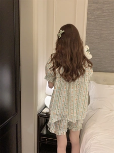 Close-up of cute cartoon bear prints on striped pajamas with ruffled hem and puff sleeves