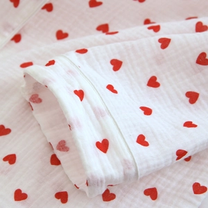 Detail of red heart prints on soft crinkle gauze pajamas with high-quality stitching