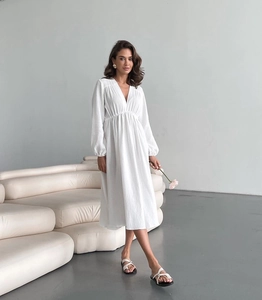Close-up of white cotton crepe robe showing V-neck and high waist pleated details