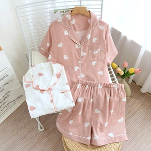 Close-up of pink heart-patterned cotton pajama set with short-sleeve shirt and shorts