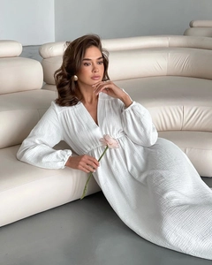 Detail of white long sleeve cotton gauze robe featuring deep V-neck and ruffled texture