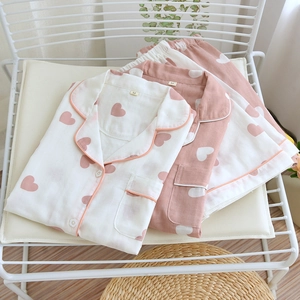 Detail of cotton pajama set with heart pattern showing button-down top and matching pants