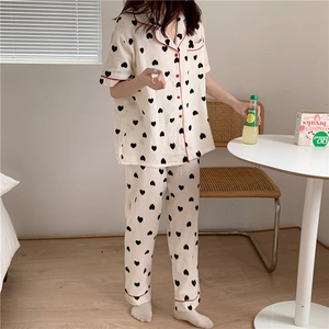 Close-up of heart print cotton pajamas set with red piping and breathable texture
