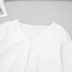 Detailed view of the V-neck cotton gauze shirt with pocket and textured buttons