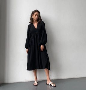 Detail of V-neck cotton crepe robe with lantern sleeves and textured fabric detail