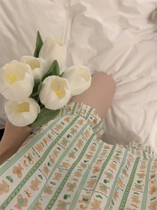 Detail of cartoon bear print and green plaid pattern on soft cotton loungewear set