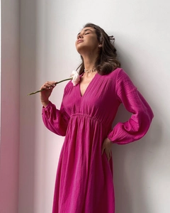 Detailed texture of fuchsia cotton crepe fabric on a long sleeve V-neck lounge robe