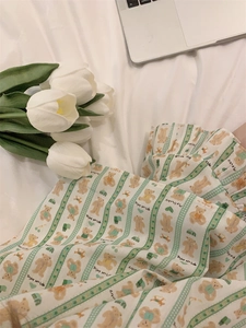 Detail of cartoon bear and heart patterns on striped cotton blend home wear fabric