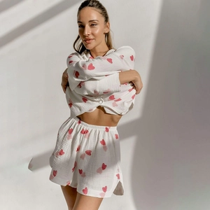 Women's white cotton pajama set with pink heart prints featuring long sleeve top and shorts