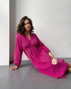 Detailed close-up of breathable rose red crepe cotton fabric and elastic cuffs on robe