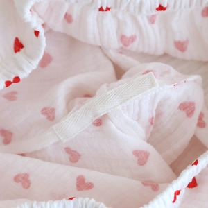 Macro detail of elastic waistband and heart patterns on cotton gauze pajama fabric