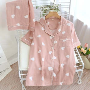 Short sleeve pink cotton pajama set for women with white heart print and button design