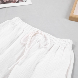 Detailed close-up of white double-layered cotton gauze pajama shorts with elastic waist