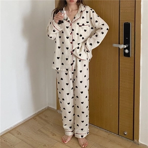 Close-up of heart print pajama set with red piping and chest pocket details