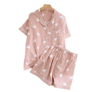 Pink short sleeve cotton pajama set for women with white heart print and button down top