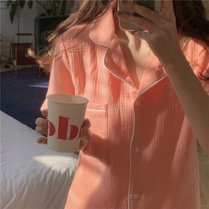 Detail of peach cotton gauze pajamas with white piping and textured breathable fabric