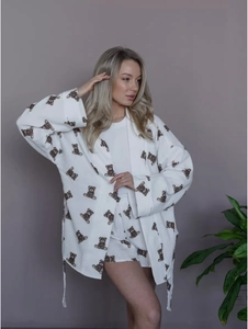 Detail of white cotton waffle pajama set with cute brown cartoon bear prints