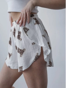 Detail view of cotton pajama shorts with cute brown bear prints and side slit design