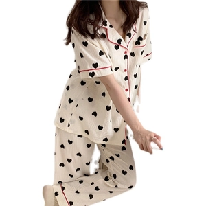 Women's two-piece cotton pajama set with black heart print and red piping detail