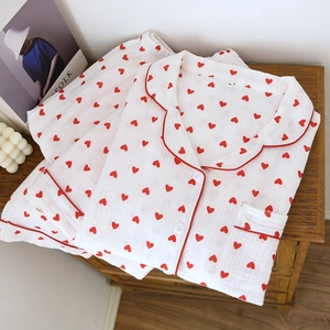 Women's cotton crepe pajama set with red heart print and pants on wooden background