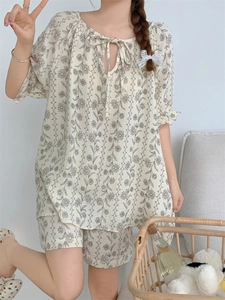 Detail of vintage tie-neck floral pajama set with breathable cotton fabric and shorts