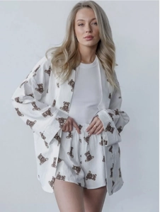 Detail of white cotton pajamas with cute brown bear prints on shirt and shorts