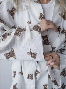 Close-up of soft double-layer cotton gauze fabric with cute brown cartoon bear patterns