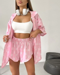 Detail of pink satin lounge set with white gothic letter print and elastic waist shorts