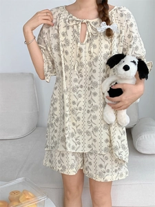 Detailed view of women's floral pajamas set with drawstring neckline and lace details