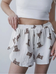 Detail of white cotton pajamas shorts with brown bear print and elastic waistband