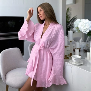 Detailed texture of pink cotton gauze robe with ruffle sleeves and waist tie design