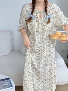 Detail of floral vintage pajamas with lace-up neckline and puffed sleeve texture