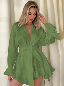 Detail of green cotton crepe wrap set featuring ruffled cuffs and tie-waist texture