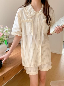 Detail of cream tassel trim and black dotted stripes on women short sleeve pajama set