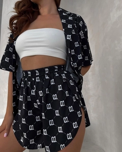 Detailed macro shot of 3-piece set featuring black and white patterned shirt and high waist shorts
