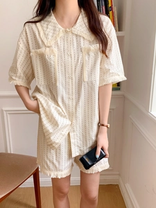 Detail of cream polka dot pajama set with short sleeves and elegant tassel fringes