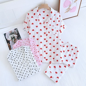 Gros plan du pyjama en coton à motif cœurs montrant la texture et le col à boutons