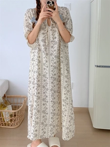 Close-up of summer floral home wear dress with delicate ties and puff sleeve details