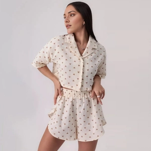 Close-up of lightweight summer pajama set with heart print and button-up lapel shirt