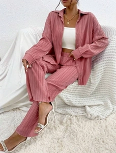 Detail of mauve pleated two-piece set showing premium draped texture and ribbed fabric