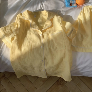 Detail view of yellow seersucker pajamas set showing soft breathable gauze fabric texture
