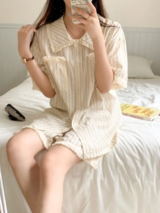 Detail of striped short-sleeve pajamas featuring fringe trim and soft cotton fabric