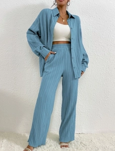 Detailed texture of blue pleated two-piece set featuring vertical crinkle fabric