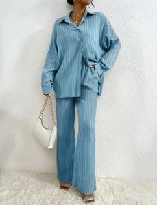 Detail of light blue two-piece set featuring pleated fabric texture and relaxed loose fit